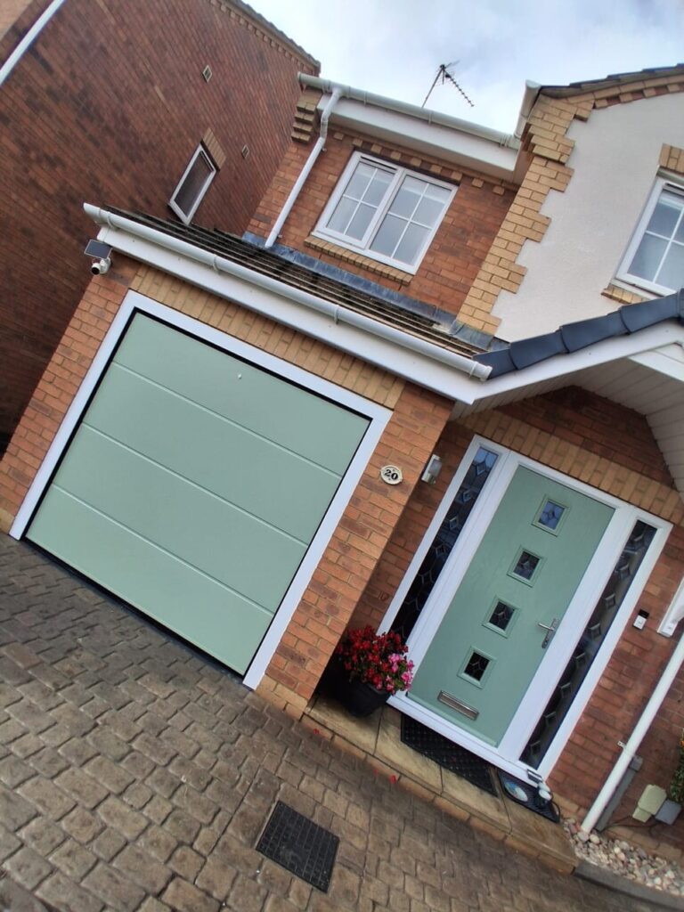 Green sectional garage door and matching composite front door, Daventry