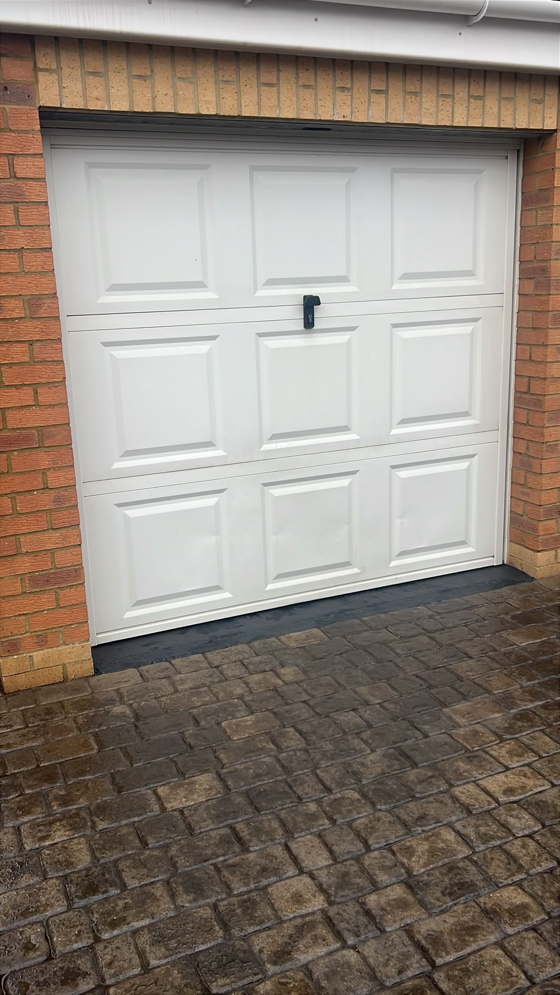 Daventry garage door – before Old white up and over garage door before replacement in Daventry